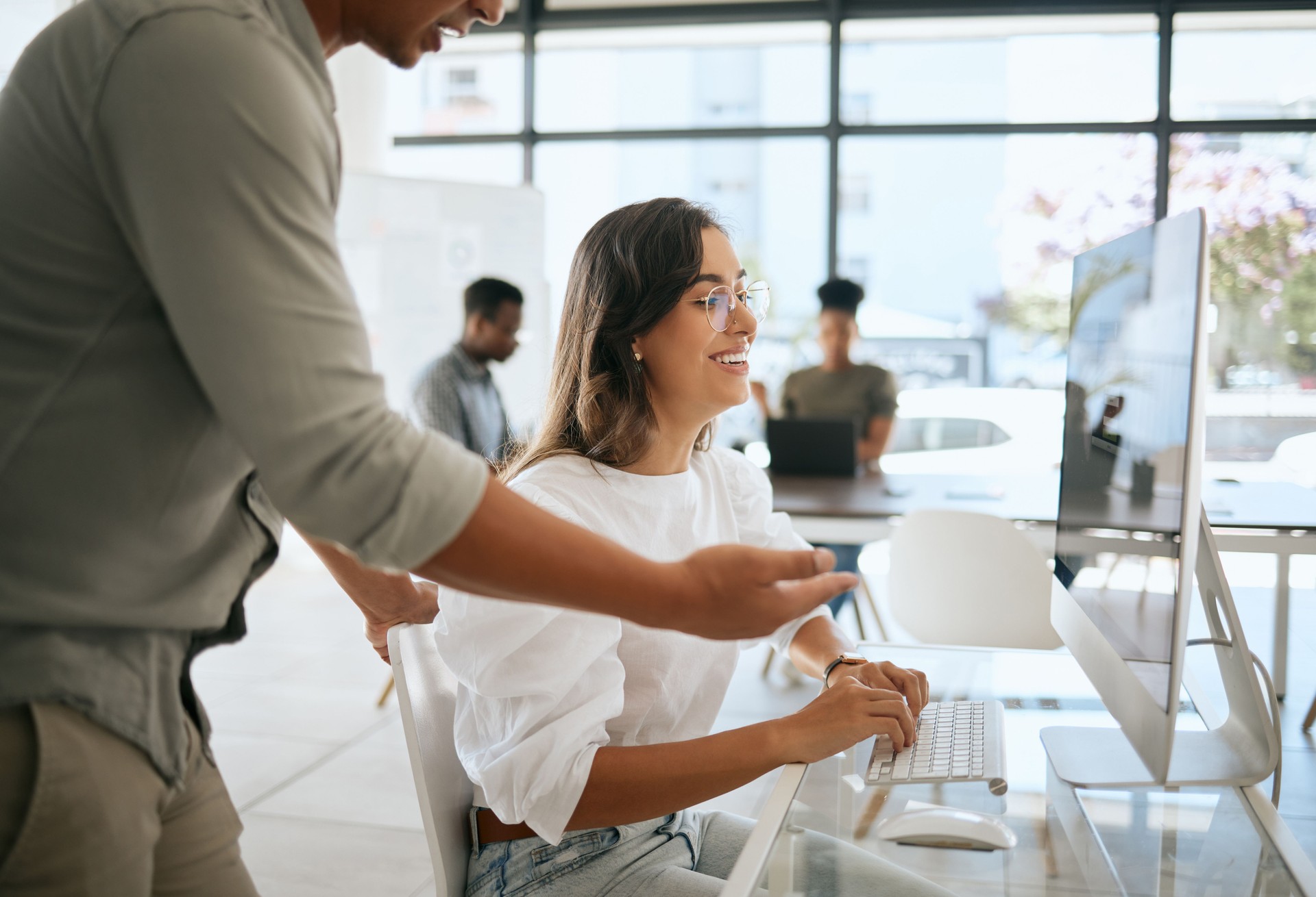 Employees working, collaboration and strategy on computer, software technology and planning in modern office agency. Manager coaching happy business woman, desktop pc and training, web design or idea